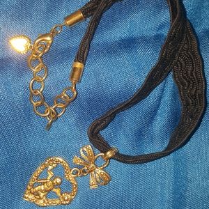 Goldtone cherub in a heart chocker